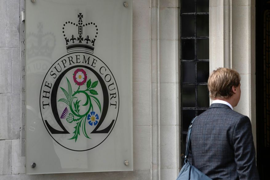 FILE - A man enters the Supreme Court in London, on Oct. 9, 2023. (AP Photo/Kin Cheung, File)
