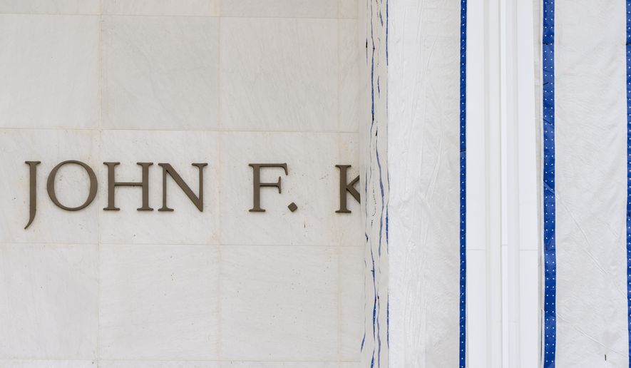 The John F. Kennedy Center for the Performing Arts is seen as its sign remains covered by a tarp, Friday, June 19, 2026, in Washington. (AP Photo/Mark Schiefelbein)
