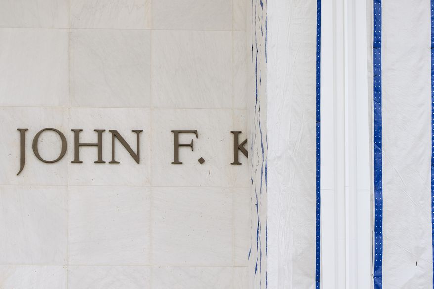 The John F. Kennedy Center for the Performing Arts is seen as its sign remains covered by a tarp, Friday, June 19, 2026, in Washington. (AP Photo/Mark Schiefelbein)