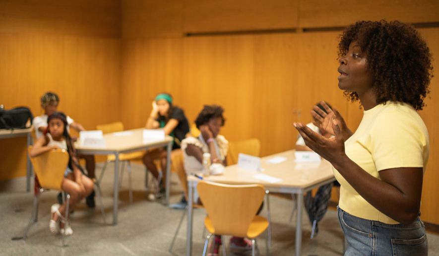 Teacher actively explains concepts to students in a classroom. File photo credit: Victor Canales Studio via Shutterstock.