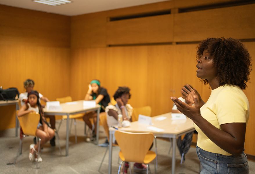 Teacher actively explains concepts to students in a classroom. File photo credit: Victor Canales Studio via Shutterstock.