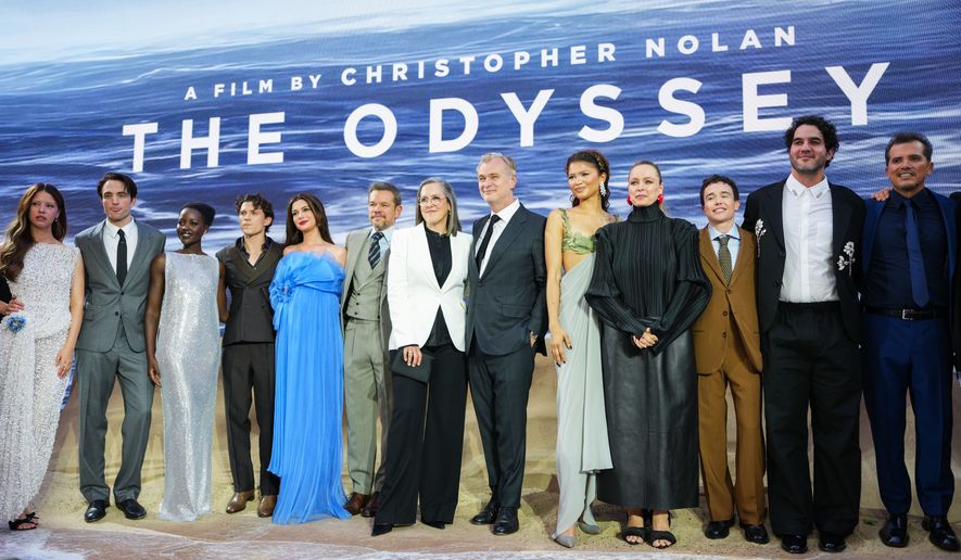 Mia Goth, from left, Robert Pattinson, Lupita Nyong'o, Tom Holland, Anne Hathaway, Matt Damon, Emma Thomas, Christopher Nolan, Zendaya, Samantha Morton, Elliot Page, Benny Safdie, and John Leguizamo pose for photographers upon arrival at the premiere of the film 'The Odyssey' on Monday, July 6, 2026, in London. (Photo by Scott A Garfitt/Invision/AP)