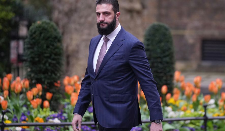 FILE - President of Syria Ahmed al-Sharaa walks towards 10 Downing Street to meet Britain's Prime Minister Keir Starmer in London, on March 31, 2026. (AP Photo/Alastair Grant, File)