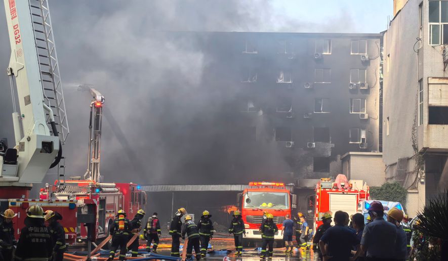 In this photo released by Xinhua News Agency, firefighters at the scene of a footwear factory fire in Jiangtou village, Chendai township of Jinjiang city, southeastern China's Fujian province, Thursday, July 9, 2026. (Zheng Liang/Xinhua via AP)