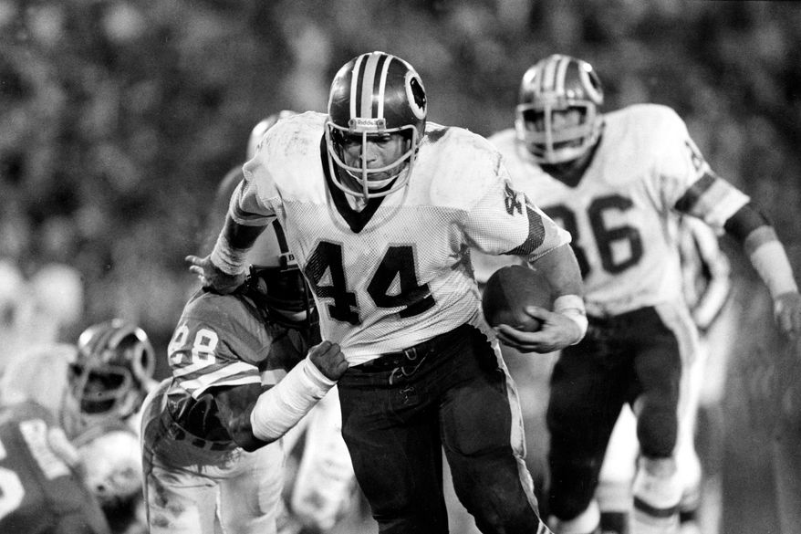 Washington Redskins running back John Riggins (44) eludes a tackle attempt by Miami Dolphins' Don McNeal (28) during NFL football's Super Bowl XVII in Pasadena, Calif., Jan. 30, 1983. (AP Photo, File)