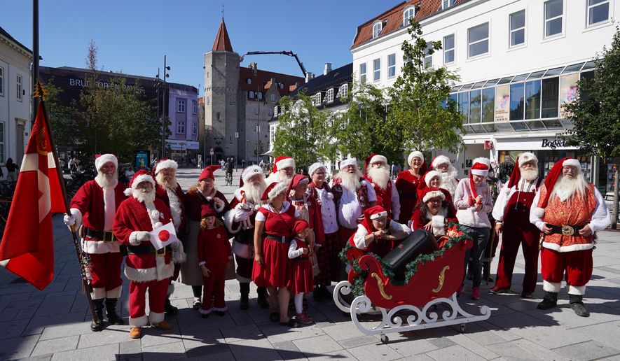 Santas, Mrs. Clauses and Christmas elves from around the world pose for a photo at the annual World Santa Claus Congress, a colorful midsummer tradition, in Aalborg, Denmark, Wednesday July 8, 2026. (AP Photo/James Brooks)