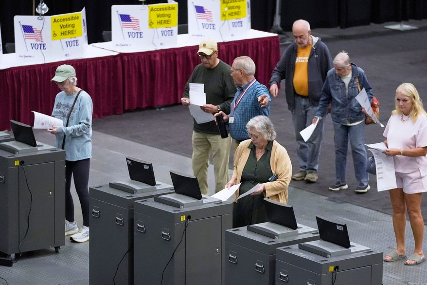 FILE - Voter cast their Maine primary ballots at the Civic Center, June 9, 2026, in Augusta, Maine. (AP Photo/Robert F. Bukaty, File)
