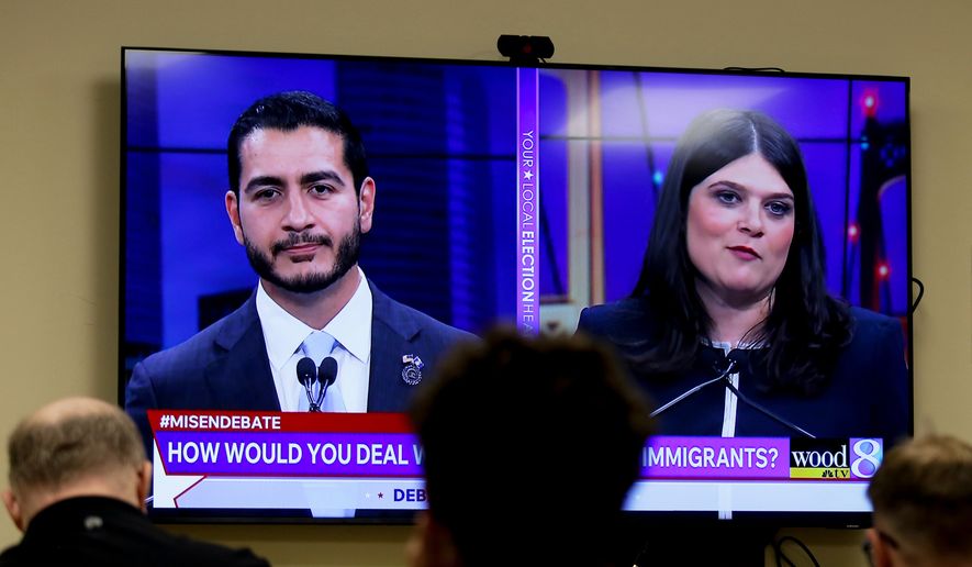 Michigan U.S. Senate candidates, Abdul El-Sayed, left, and Rep. Haley Stevens, D-Mich., are displayed on a television during a debate inside the spin room at WoodTV studios on Tuesday, July 7, 2026, in Grand Rapids, Mich. (AP Photo/Kristen Norman)