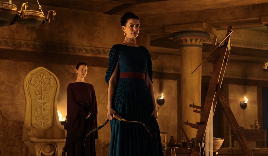This image released by Universal Pictures shows, from left, Mia Goth as Melantho, and Anne Hathaway as Penelope, in a scene from "The Odyssey." (Melinda Sue Gordon/Universal Pictures via AP)