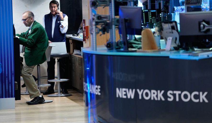 Traders work on the floor at the New York Stock Exchange in New York, Monday, July 6, 2026. (AP Photo/Seth Wenig)