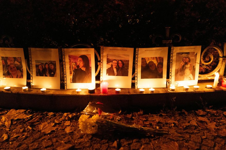 Photos showing Mackenzie Michalski, an 31-year-old American tourist who was murdered while on vacation, hang at a candlelight vigil in Budapest, Hungary, on Nov. 9, 2024. (AP Photo/Bela Szandelszky, File)