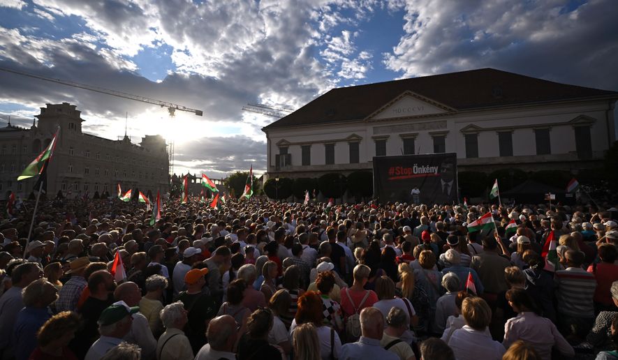 Former Hungarian President Janos Ader, center, speaks during the protest held by Fidesz and KDNP against the amendment of the Basic Law in front of the presidential Alexander Palace in Budapest, Hungary, Thursday, July 9, 2026. (Tibor Illyes/MTI via AP)