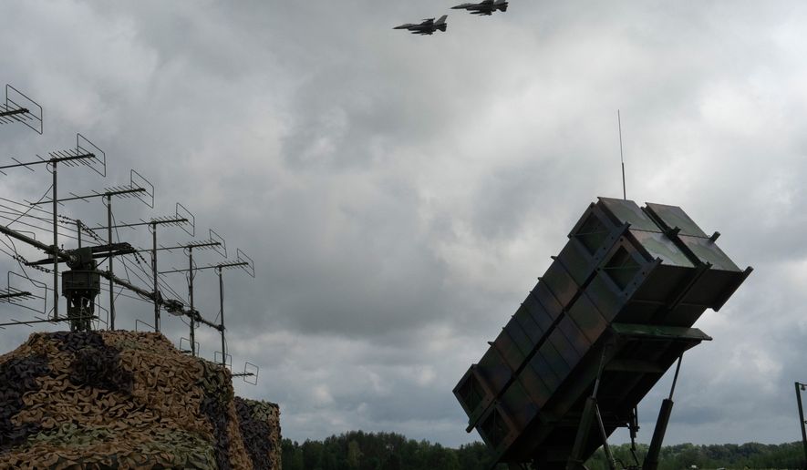 FILE - Ukrainian Air Force's F-16 fighter jets fly over a Patriot Air and Missile Defense System in an undisclosed location in Ukraine, on Aug. 4, 2024. (AP Photo/Efrem Lukatsky, File)