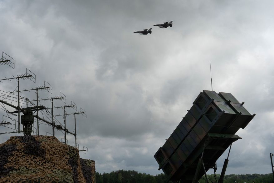FILE - Ukrainian Air Force's F-16 fighter jets fly over a Patriot Air and Missile Defense System in an undisclosed location in Ukraine, on Aug. 4, 2024. (AP Photo/Efrem Lukatsky, File)
