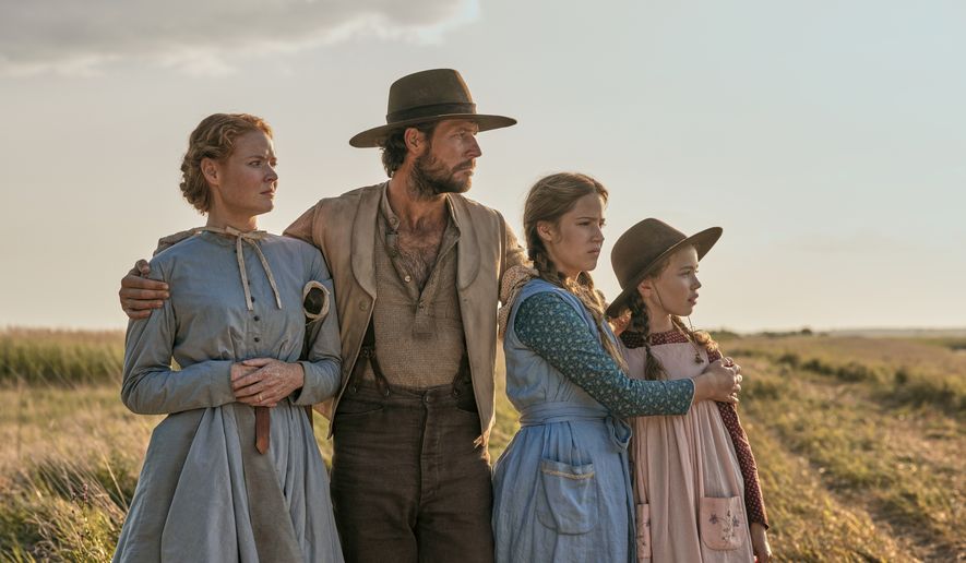 This image released by Netflix shows, from left, Crosby Fitzgerald as Caroline Ingalls, Luke Bracey as Charles Ingalls, Skywalker Hughes as Mary Ingalls, and Alice Halsey as Laura Ingalls in a scene from "Little House on the Prairie." (Eric Zachanowich/Netflix via AP)