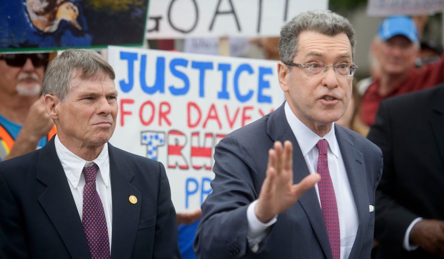 Former Olympic canoeist David Hearn, left, listens as his attorney Norman Eisen, right, speaks after he pleaded not guilty to allegedly damaging the Lincoln Memorial Reflecting Pool, Thursday, July 9, 2026, in Washington. (AP Photo/Rod Lamkey Jr.)