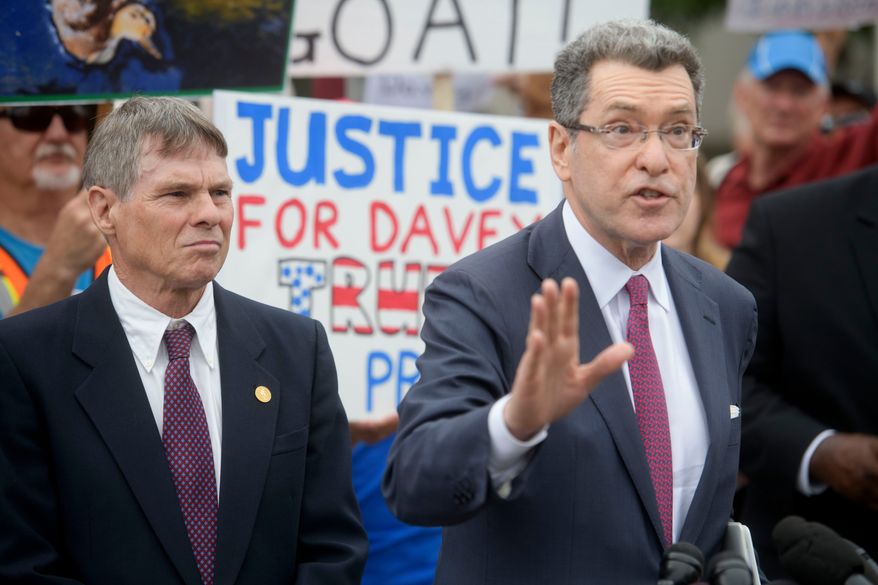 Former Olympic canoeist David Hearn, left, listens as his attorney Norman Eisen, right, speaks after he pleaded not guilty to allegedly damaging the Lincoln Memorial Reflecting Pool, Thursday, July 9, 2026, in Washington. (AP Photo/Rod Lamkey Jr.)