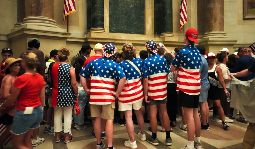 People wait to look at the original Declaration of Independence and U.S. Constitution at the National Archives Museum, Friday, July 3, 2026, in Washington. (AP Photo/Julia Demaree Nikhinson)
