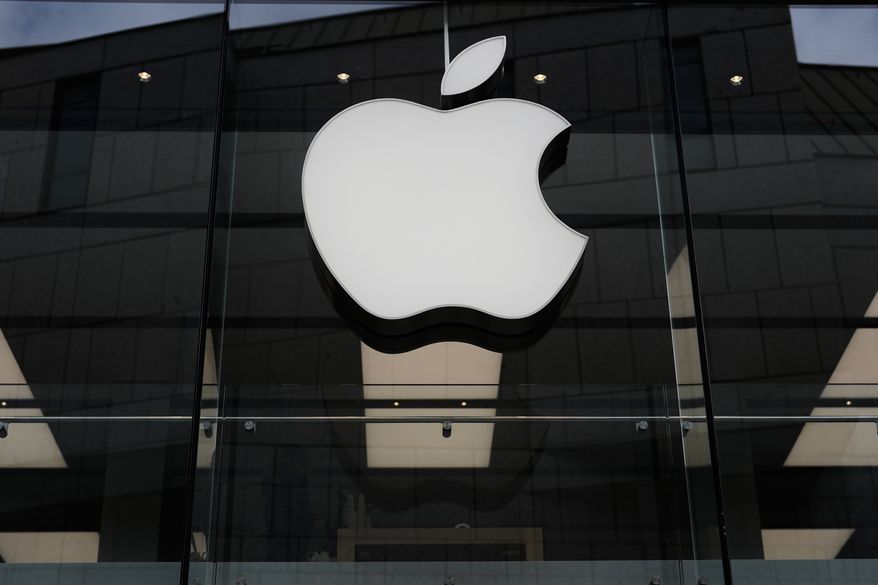 The Apple logo is illuminated at a store in Munich, April 2, 2026. (AP Photo/Matthias Schrader, File)