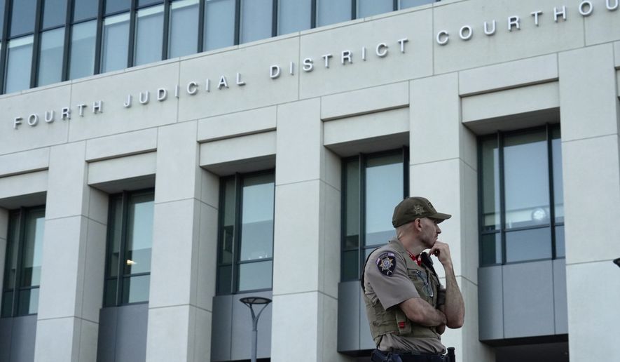 law enforcement monitors the parking lot outside the fourth judicial District courthouse where a preliminary hearing for Tyler Robinson, the Utah man accused of fatally shooting Charlie Kirk, in Provo, Utah, Friday, July 10, 2026. (AP Photo/Ty ONeil)