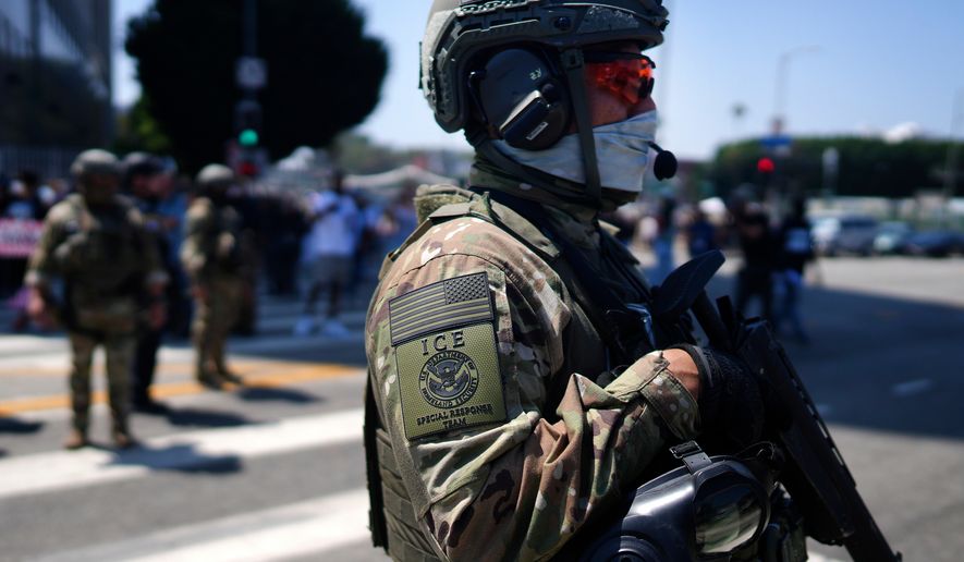 An ICE Special Response Team member stands guard outside the Metropolitan Detention Center in downtown Los Angeles while protesters gather outside to denounce ICE (Immigration and Customs Enforcement) operations on June 10, 2025. (AP Photo/Eric Thayer, File)