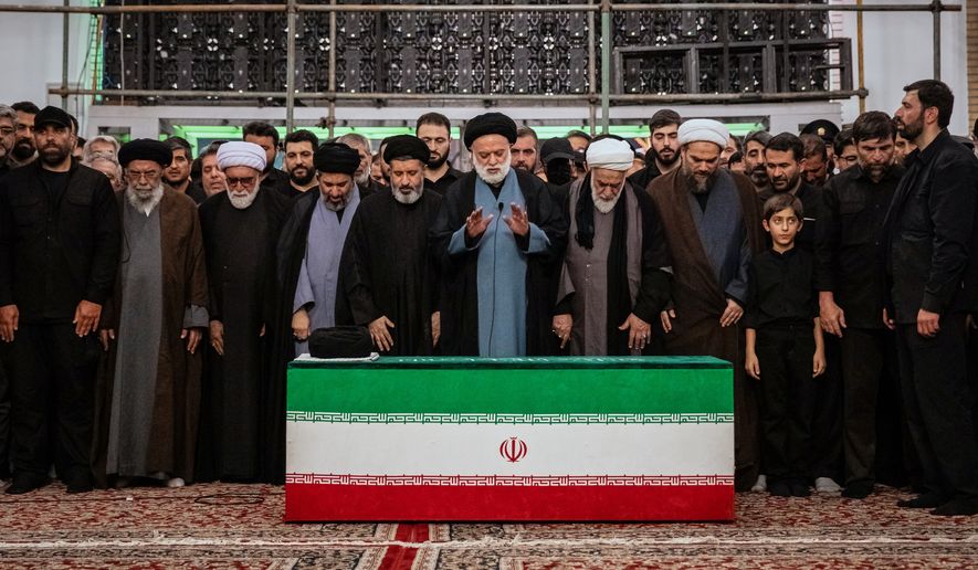 Mostafa Khamenei, center, brother of Iran's new Supreme Leader Mojtaba Khamenei, leads a prayer over the coffin of his late father, Iranian Supreme Leader Ayatollah Ali Khamenei before his burial at the Imam Reza Shrine in Mashhad, northeastern Iran, Thursday, July 9, 2026. (Office of the Iranian Supreme Leader via AP)