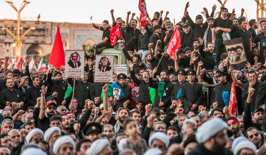 In this photo released by Iran's Supreme Leader's office, mourners chant and raise their fists during the final funeral ceremony for the late Iranian Supreme Leader Ayatollah Ali Khamenei at the Imam Reza Shrine before his burial in Mashhad, northeastern Iran, Thursday, July 9, 2026. (Office of the Iranian Supreme Leader via AP)