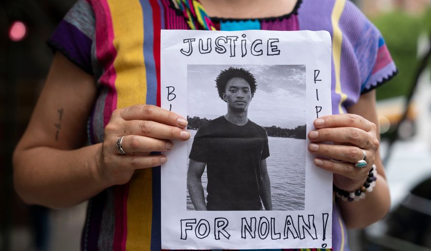 A person holds a picture of Nolan Xavier Wells during a news conference at National Action Network headquarters, Friday, July 10, 2026, in New York. (AP Photo/Yuki Iwamura)