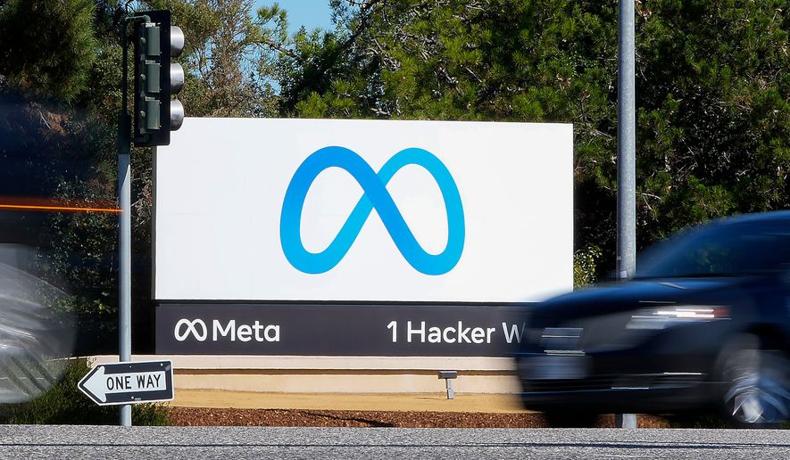 A car passes Facebook's new Meta logo on a sign at the company headquarters on Oct. 28, 2021, in Menlo Park, Calif. (AP Photo/Tony Avelar, File)