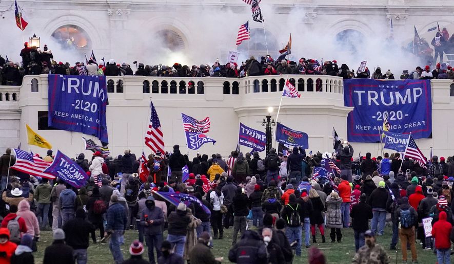 Rioters supporting President Donald Trump storm the Capitol in Washington, Jan. 6, 2021. (AP Photo/John Minchillo, File)