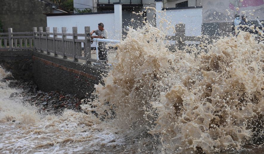 Huge waves crash on the coastline ahead of Typhoon Bavi in Wenling in eastern China's Zhejiang province, Friday, July 10, 2026. (Chinatopix Via AP) CHINA OUT