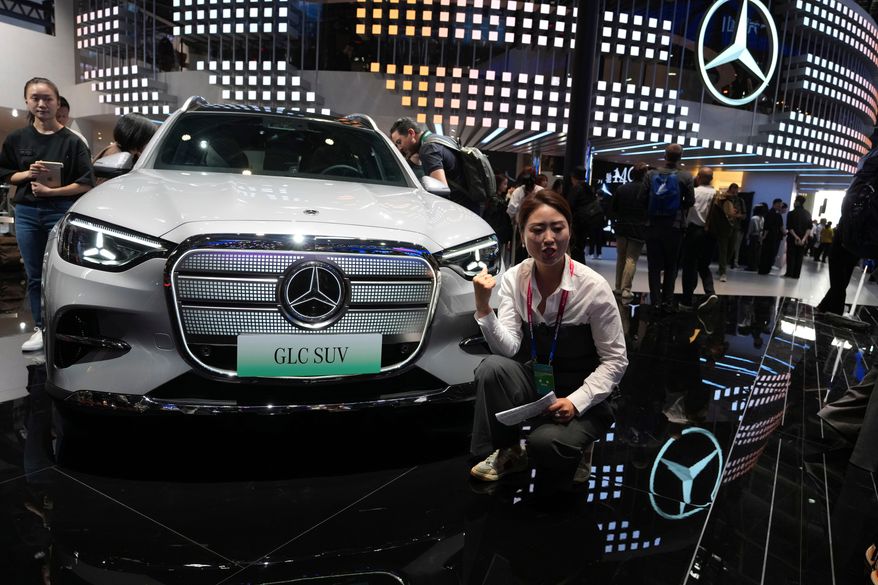 A vlogger promotes the GLC SUV at the Mercedes-Benz booth during Auto China 2026 in Beijing, on April 24, 2026. Major German carmakers saw sharp quarterly sales declines in China, as domestic demand weakened and competition heats up in the world’s biggest auto market. (AP Photo/Ng Han Guan)