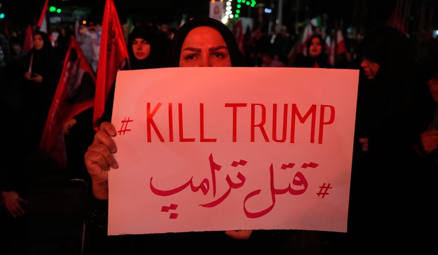 A pro-government demonstrator holds an anti-Trump placard in a gathering commemorating the late Iranian Supreme Leader Ayatollah Ali Khamenei at a square in Tehran, Saturday, July 11, 2026. (AP Photo/Vahid Salemi)