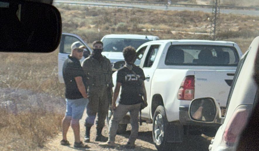 In this photo provided by Cameron Kasky, armed men block the road, stopping vehicles containing U.S. Rep. Ro Khanna, D-Calif., and his delegation near the West Bank village of Khirbet Zanuta, Wednesday, July 8, 2026. (Cameron Kasky via AP)