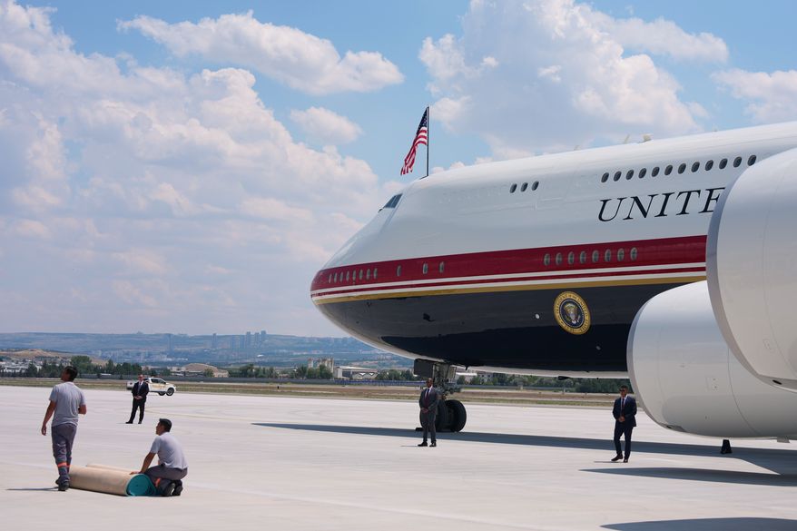 Staff lay a carpet on the tarmac before President Donald Trump exits Air Force One upon arriving for the NATO summit in Ankara, Turkey, Tuesday, July 7, 2026. (AP Photo/Alex Brandon)