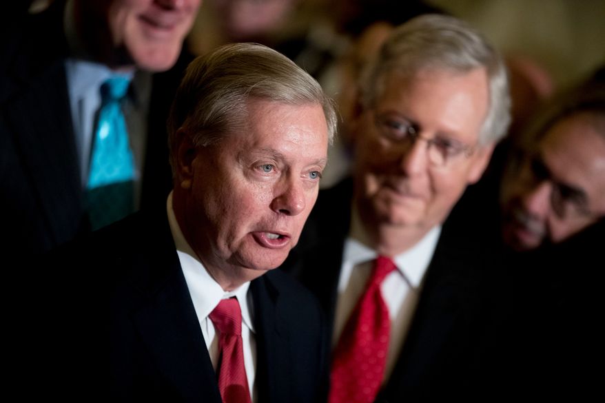 Sen. Lindsey Graham, R-S.C., flanked by Senate Majority Leader Mitch McConnell, R-Ky., right, speaks to reporters at the Capitol in Washington, Sept. 26, 2017. (AP Photo/Andrew Harnik, File)