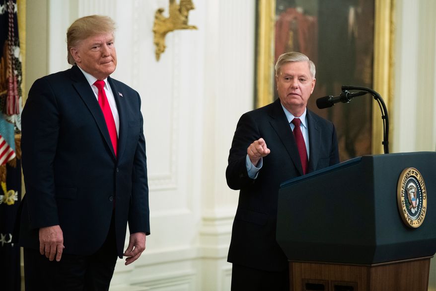 President Donald Trump listens to Sen. Lindsey Graham, R-S.C., speak during a ceremony in the East Room of the White House, Nov. 6, 2019, in Washington. (AP Photo/Manuel Balce Ceneta, File)