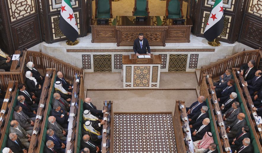 Syrian President Ahmad al-Sharaa addresses the inaugural session of Syria's newly formed People's Assembly, the first since the fall of President Bashar Assad's government, in Damascus, Syria, Sunday, July 12, 2026. (AP Photo/Ghaith Alsayed)
