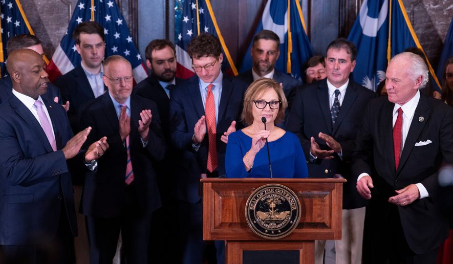 Newly appointed U.S. interim Senator, Darline Graham Nordone, with South Carolina Gov. Henry McMaster, right, and Sen. Time Scott (R-SC), left, speaks to members of the press after being appointed of to fill the vacancy created by the passing of her brother, U.S. Senator Lindsey Graham, at the statehouse Monday, July 13, 2026, in Columbia, S.C. (AP Photo/Sean Rayford)