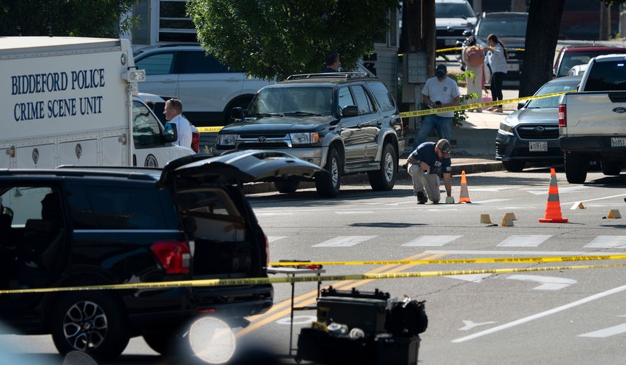 An FBI official places an evidence card where a man was reportedly killed in a shooting involving U.S. Immigration and Customs Enforcement agents, Monday, July 13, 2026 in Biddeford, Maine. (Gregory Rec/Portland Press Herald via AP)