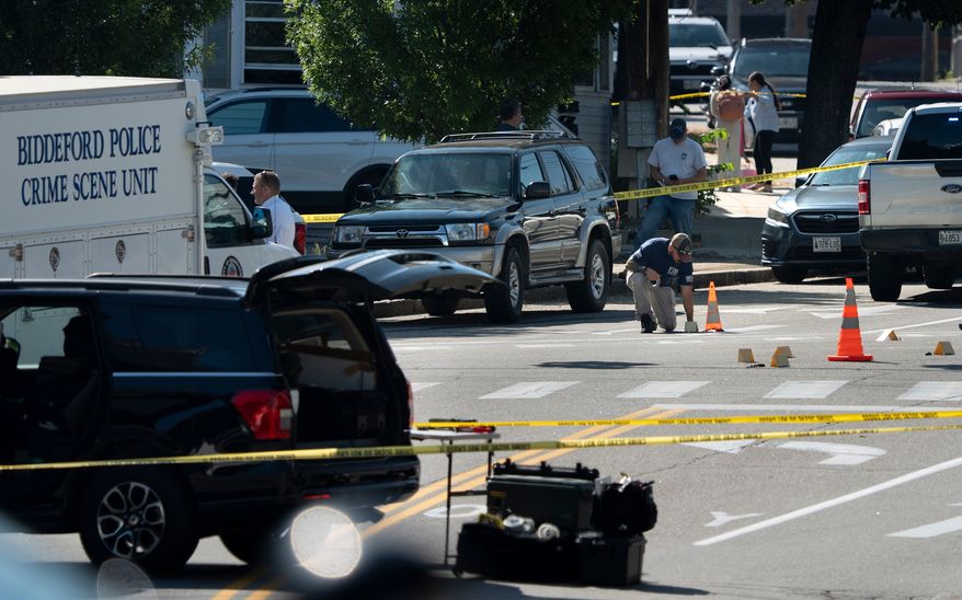 An FBI official places an evidence card where a man was reportedly killed in a shooting involving U.S. Immigration and Customs Enforcement agents, Monday, July 13, 2026 in Biddeford, Maine. (Gregory Rec/Portland Press Herald via AP)