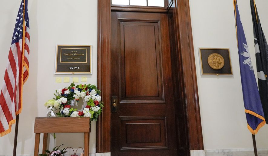 Notes and flowers outside the office of Sen. Lindsey Graham, R-S.C., in the Russell Senate Office Building on Capitol Hill in Washington, Monday, July 13, 2026, after the sudden death of Graham. (AP Photo/Mariam Zuhaib)