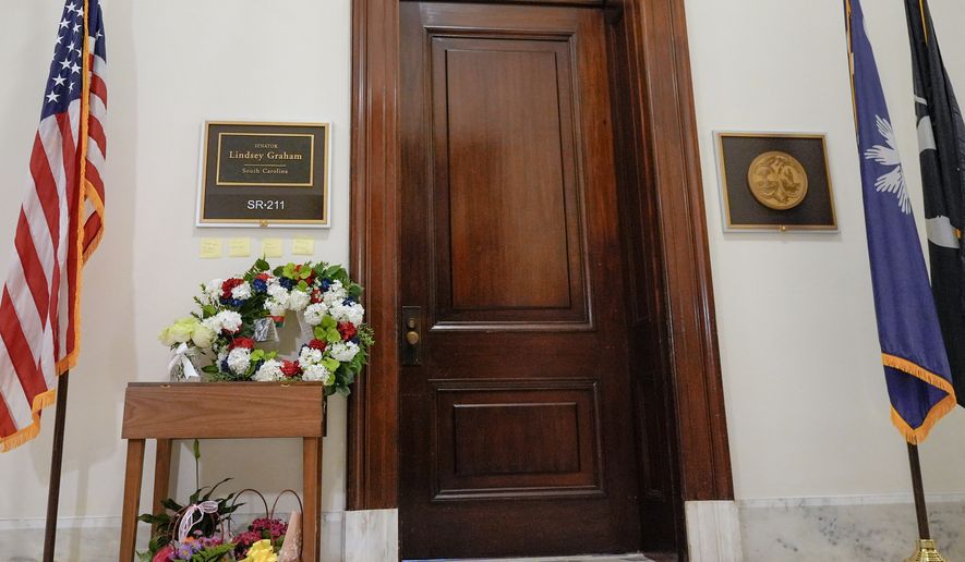 Notes and flowers outside the office of Sen. Lindsey Graham, R-S.C., in the Russell Senate Office Building on Capitol Hill in Washington, Monday, July 13, 2026, after the sudden death of Graham. (AP Photo/Mariam Zuhaib)
