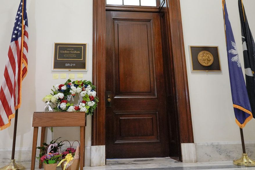 Notes and flowers outside the office of Sen. Lindsey Graham, R-S.C., in the Russell Senate Office Building on Capitol Hill in Washington, Monday, July 13, 2026, after the sudden death of Graham. (AP Photo/Mariam Zuhaib)
