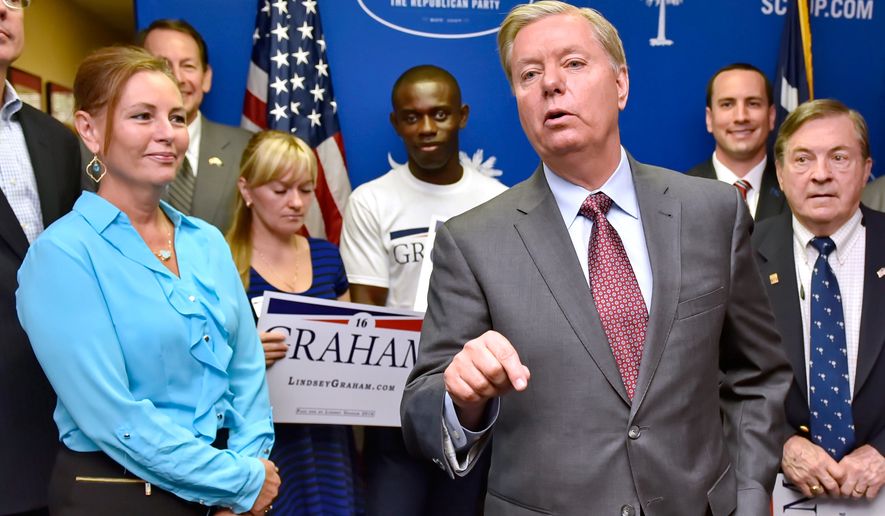 Republican presidential candidate and Sen. Lindsey Graham, R-S.C., accompanied by his sister Darline, left, speaks Sept. 1, 2015, at the GOP headquarters in Columbia, S.C., where he filed for the South Carolina presidential primary. (AP Photo/Richard Shiro) **FILE**