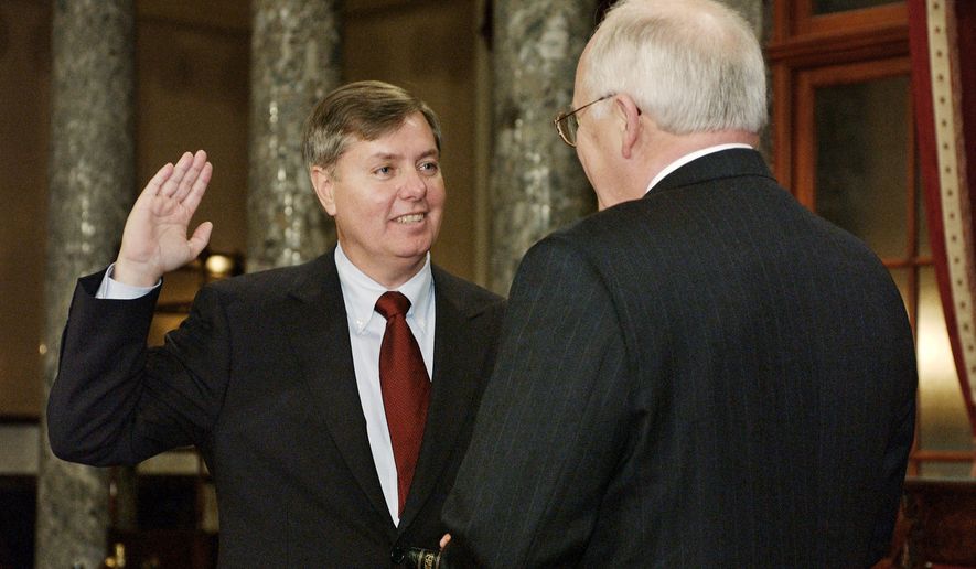 FILE - Sen. Lindsey Graham, R-S.C., takes the oath of office with Vice President Dick Cheney, right, during a re-enactment swearing-in ceremony in the Old Senate Chamber on Capitol Hill in Washington, Jan. 7, 2003, following his election to the Senate. (AP Photos/Evan Vucci, File)