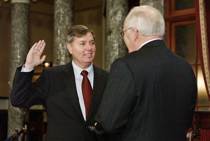 FILE - Sen. Lindsey Graham, R-S.C., takes the oath of office with Vice President Dick Cheney, right, during a re-enactment swearing-in ceremony in the Old Senate Chamber on Capitol Hill in Washington, Jan. 7, 2003, following his election to the Senate. (AP Photos/Evan Vucci, File)