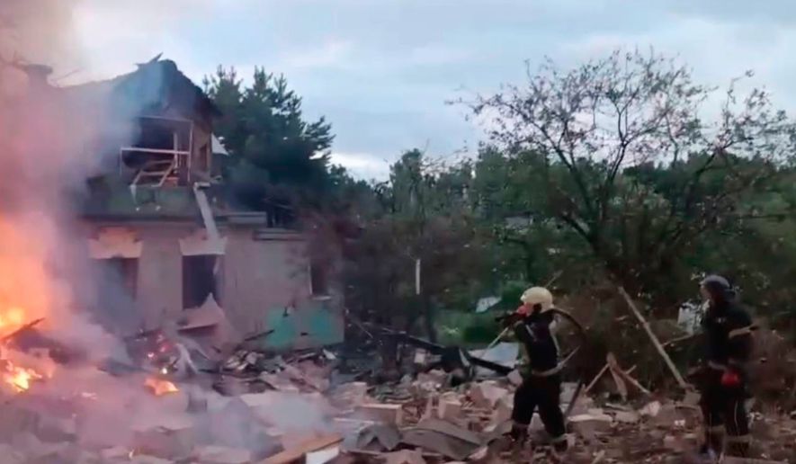 This photo released by Moscow Region Governor Andrei Vorobyev's official telegram channel shows firefighters working to extinguish a fire at a house burning after being damaged during a Ukrainian drone attack in Moscow region of Russia, on Monday, July 13, 2026. (Moscow Region Governor Andrei Vorobyev's official telegram channel via AP)