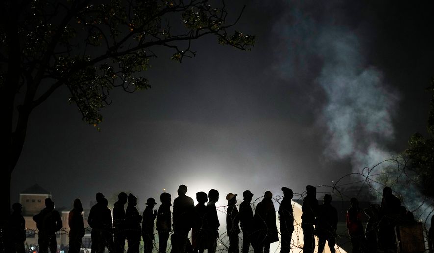 Malawian migrants stand in a queue for their deportation at a temporary centre, in Durban, South Africa, Thursday, June 18, 2026. (AP Photo/Themba Hadebe)