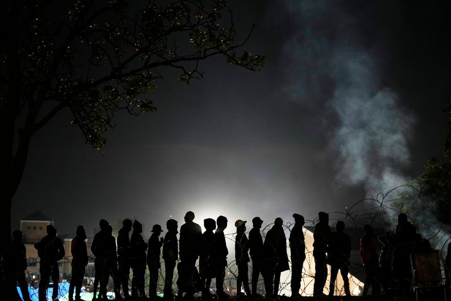 Malawian migrants stand in a queue for their deportation at a temporary centre, in Durban, South Africa, Thursday, June 18, 2026. (AP Photo/Themba Hadebe)